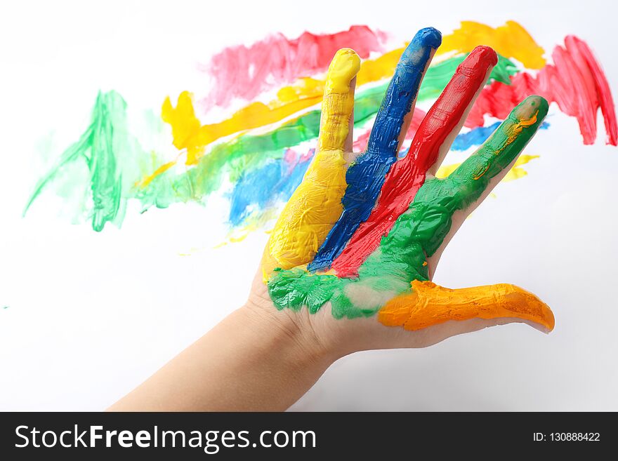 Child with painted palm on color background, closeup