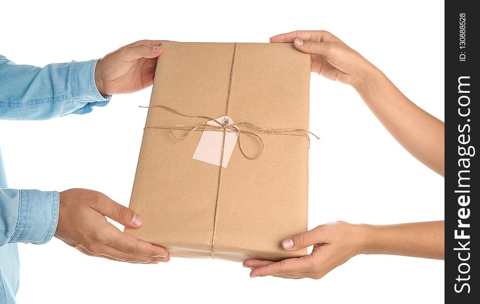 Woman receiving parcel from courier on white background, closeup