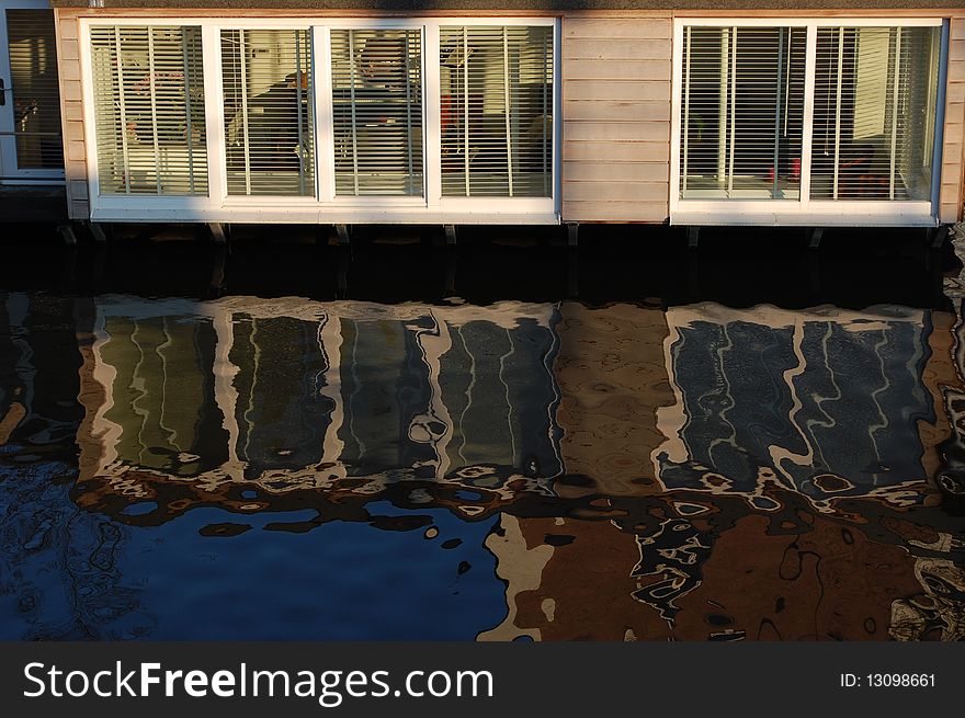 A floating boat in Amsterdam reflecting in the water. A floating boat in Amsterdam reflecting in the water