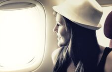 Young Woman Is Looking Through A Window In The Airplane Royalty Free Stock Image