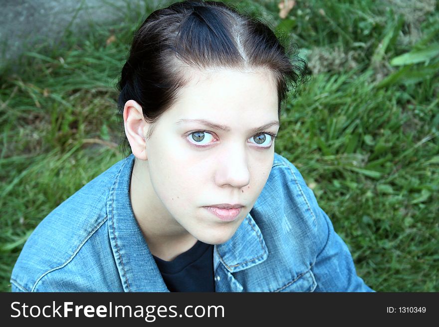 Young woman on the green in the nature