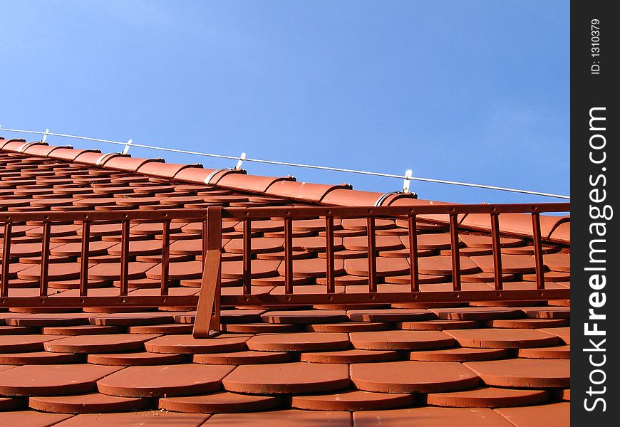 A part of roof on my house with red tile