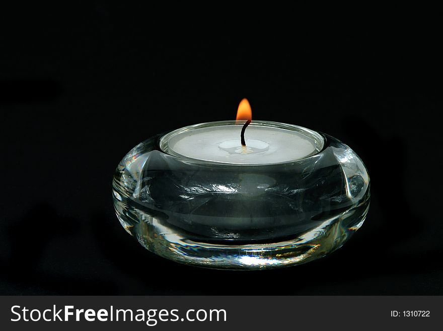 Candle lighted on black background. Candle lighted on black background