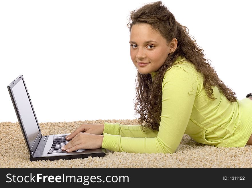 Isolated on white female teenager lying on the carpet with laptop