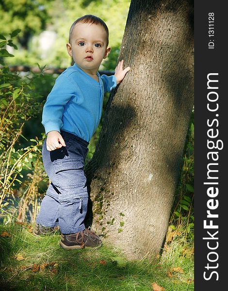 Adorable little boy playing in a park. Adorable little boy playing in a park