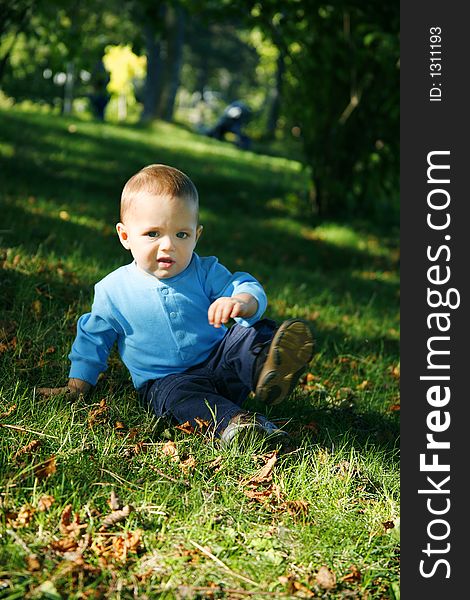 Adorable little boy playing in a park. Adorable little boy playing in a park