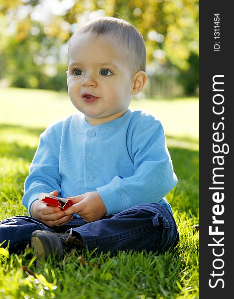 Adorable little boy playing in a park. Adorable little boy playing in a park