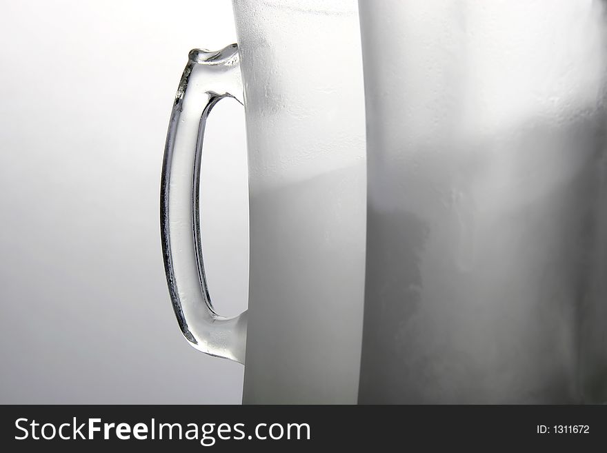 Two frozen beer mugs on a table. Two frozen beer mugs on a table