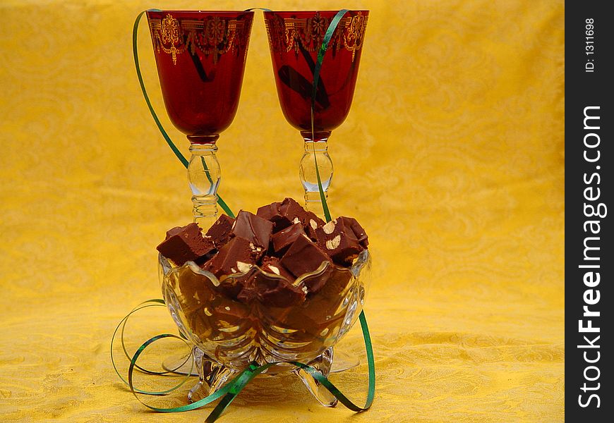 Photo of red holiday glasses and chocolate almond fudge using star filter. Photo of red holiday glasses and chocolate almond fudge using star filter.