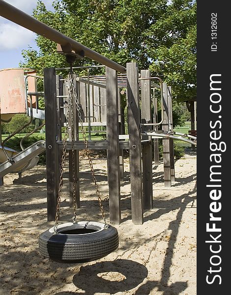 Playground equipment made of wood, chains, steel and a tire. Playground equipment made of wood, chains, steel and a tire