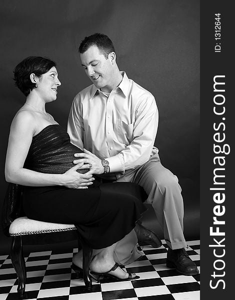 Black and white portrait of a pregnant woman and her husband. Black and white portrait of a pregnant woman and her husband.