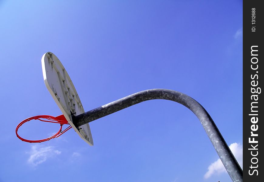 A not so typical angle on a basketball hoop isolated against the sky. A not so typical angle on a basketball hoop isolated against the sky