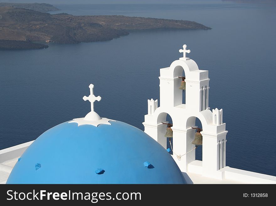 The dome and bells of a church in Santorini, Greece. The dome and bells of a church in Santorini, Greece