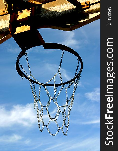 Looking upward thru a basketball hoop and the net is made of chain (instead of rope). Looking upward thru a basketball hoop and the net is made of chain (instead of rope)