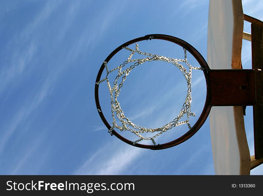Looking upward thru a basketball hoop and the net is made of chain (instead of rope). Looking upward thru a basketball hoop and the net is made of chain (instead of rope)