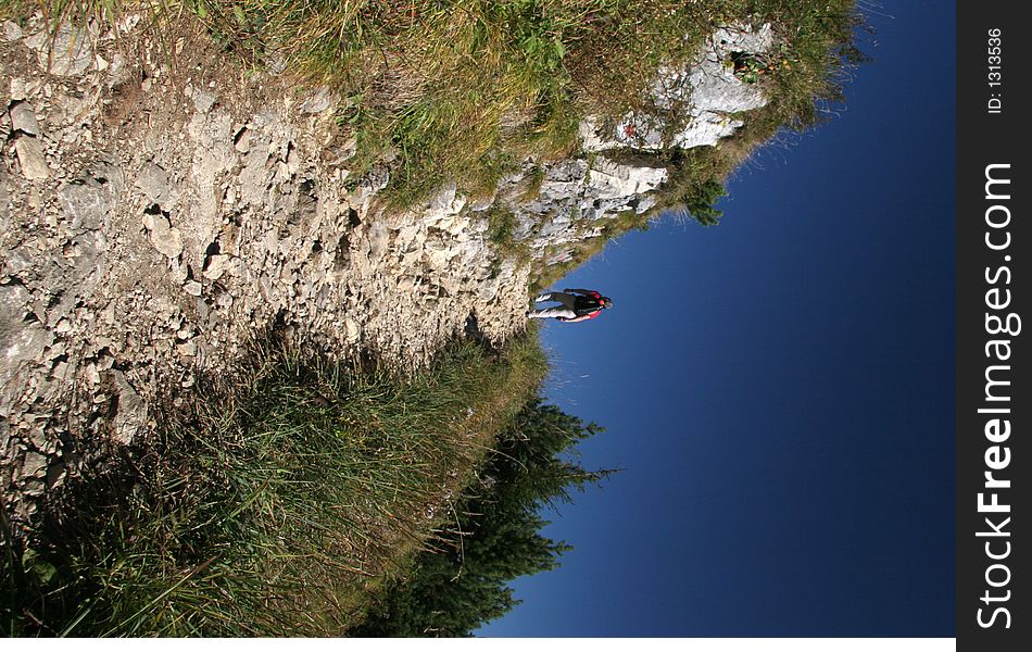 Mountaineer walking a hillside way