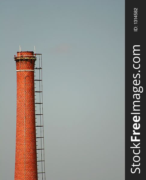 Brick industrial chimney against sky. Brick industrial chimney against sky