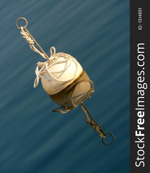 WHITE BUOY REFLECTING IN CALM WATER