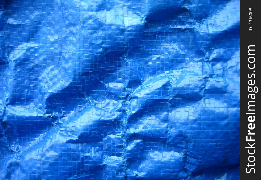 Wrinkled blue tarpaulin makes a complex background