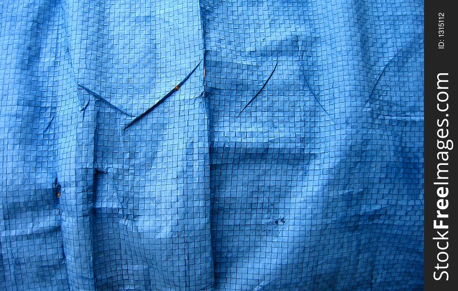 Wrinkled blue tarpaulin makes a complex background