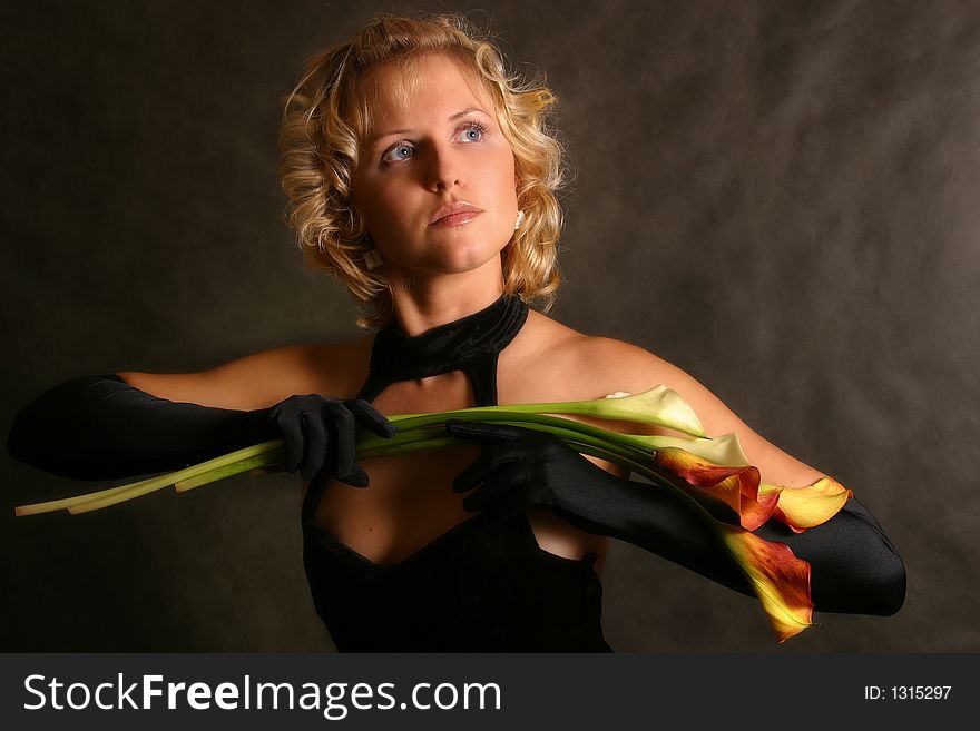 Portrait of the girl in a black dress with callas. Portrait of the girl in a black dress with callas