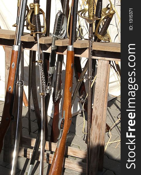 Rack of vintage weaponry at reenactment-show