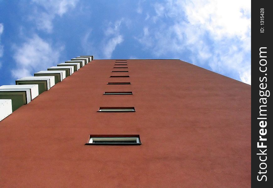 A modern red building on a warm summer day. A modern red building on a warm summer day.