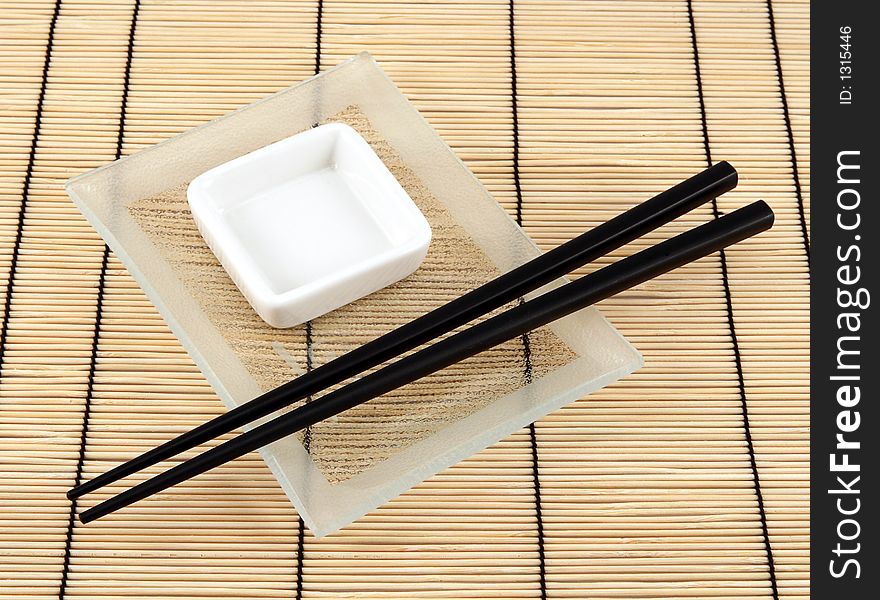Sushi plate and chopsticks on bamboo mat. Sushi plate and chopsticks on bamboo mat