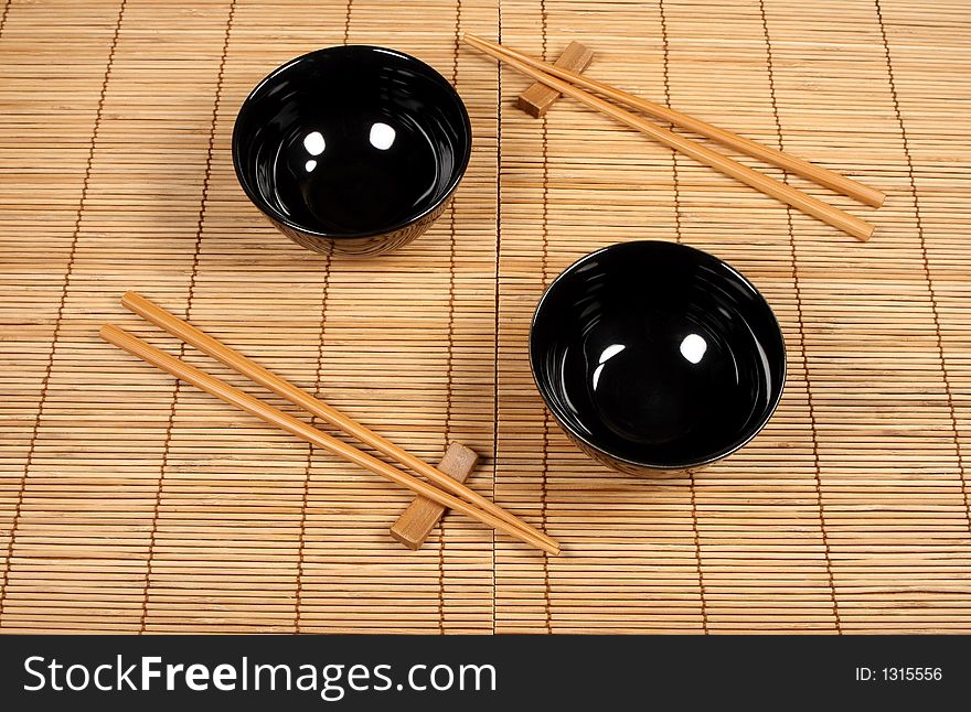 Sushi plates and chopsticks on bamboo mat. Sushi plates and chopsticks on bamboo mat