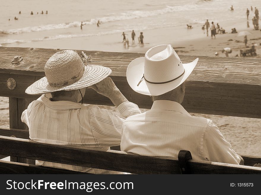 Old-fashioned treatment of a married couple enjoying a view of Californian beach. Old-fashioned treatment of a married couple enjoying a view of Californian beach