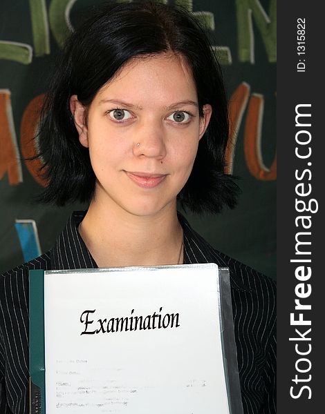 Young woman with the paper of her examination. Young woman with the paper of her examination