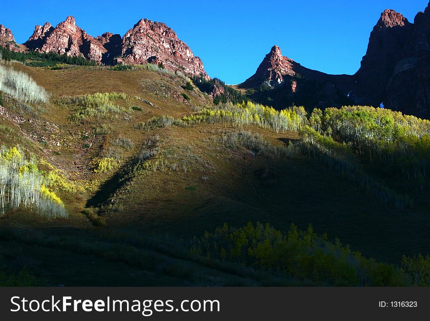 Red rocks and aspen trees.