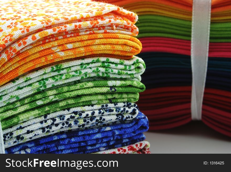 Bundle of coloured material on a white background