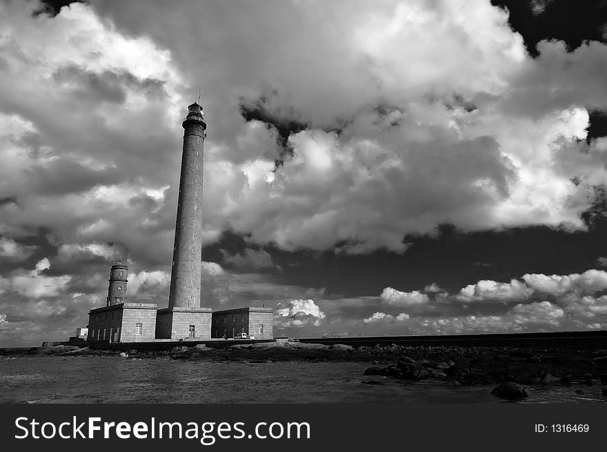 A lighthouse in Normandy France with large cloudscape. A lighthouse in Normandy France with large cloudscape