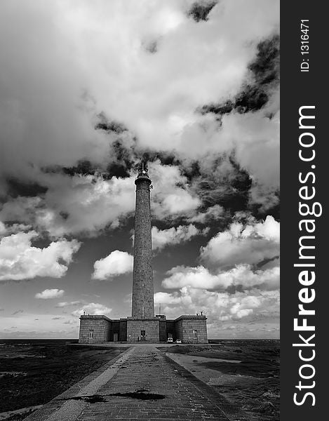 A lighthouse in Normandy France with large cloudscape. A lighthouse in Normandy France with large cloudscape