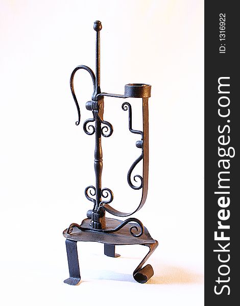 An old branched candlestick wrought iron made. An old branched candlestick wrought iron made