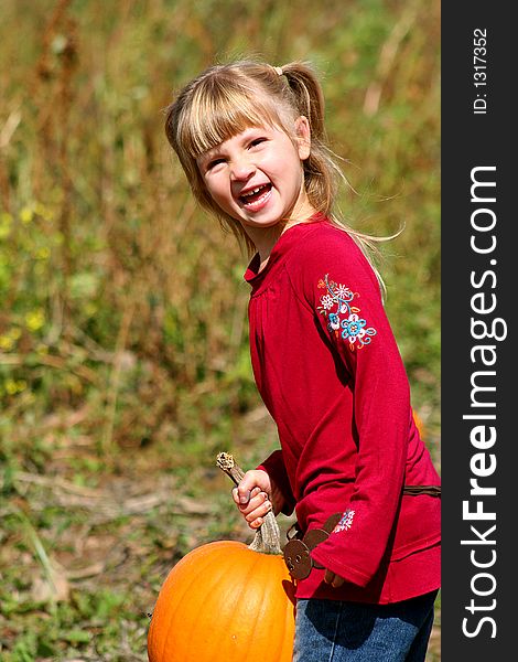 Little girl looking for the perfect pumpkin. Little girl looking for the perfect pumpkin.