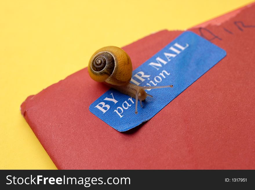 A snail crawls over a par avion (air mail) stamp on a letter to represent snail mail. A snail crawls over a par avion (air mail) stamp on a letter to represent snail mail.