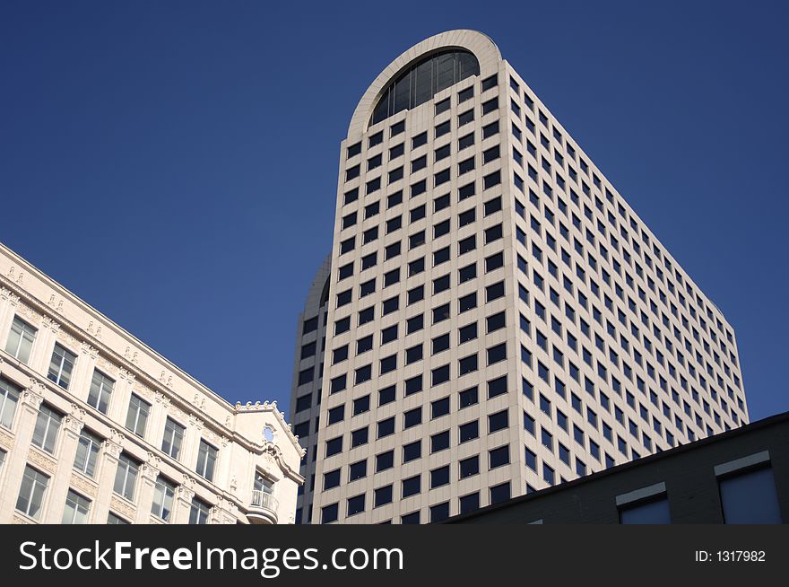 Arched downtown highrise under blue sky