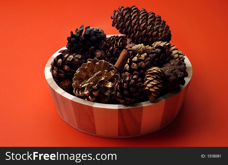 An arrangement of scented pinecones on a red background. An arrangement of scented pinecones on a red background
