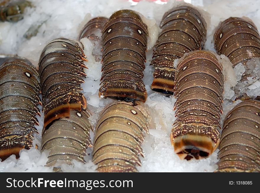 Fresh lobster tails on ice at the market