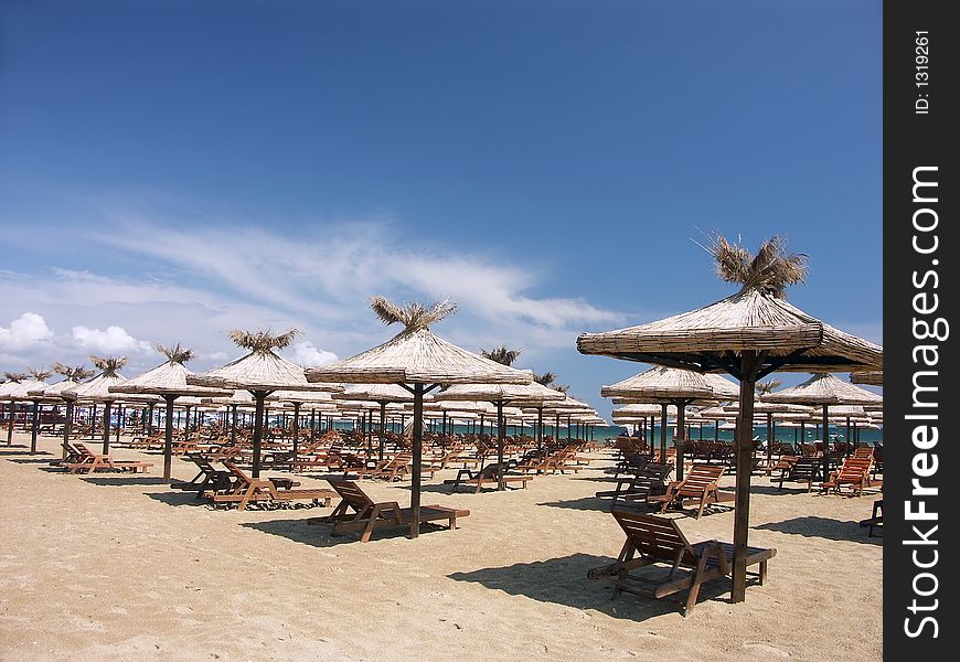 Straw shade umbrellas on a beach. Straw shade umbrellas on a beach