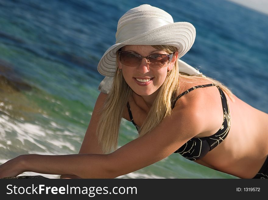 Blond long-haired smiling girl with sunglasses