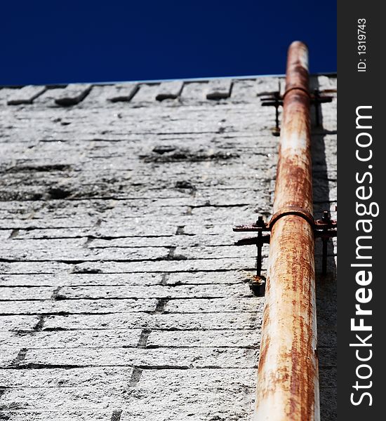 Rusty pipe on a white wall background. Rusty pipe on a white wall background