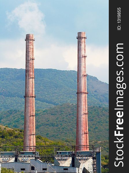 Two very similar factory chimney of cement works. Two very similar factory chimney of cement works