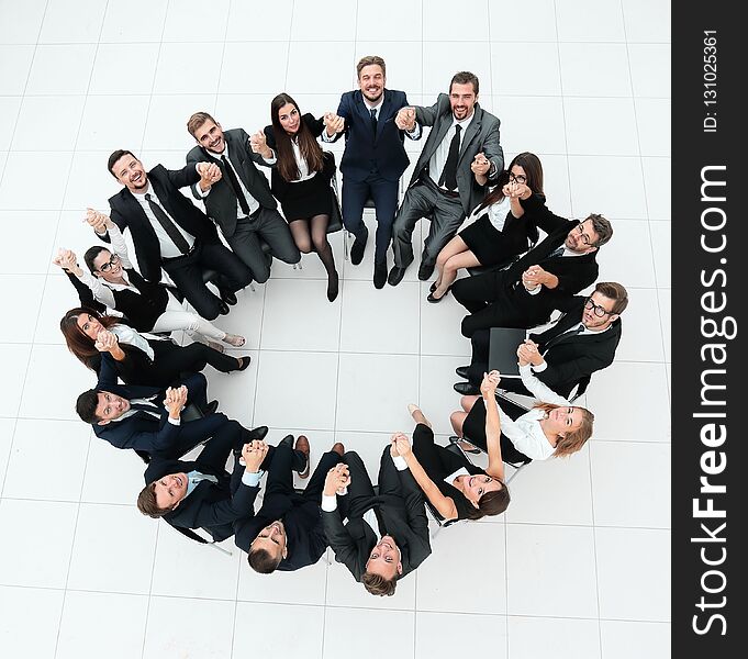 Concept of team building.large business team sitting in a circle