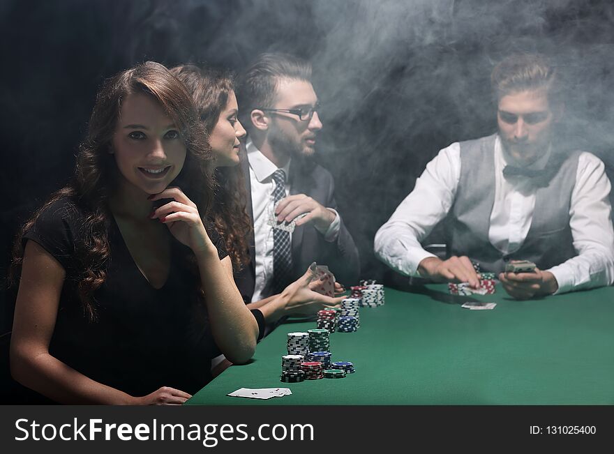 Modern business woman sitting at craps table in a casino.