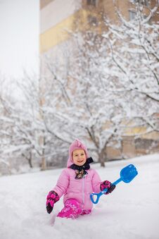 The Child Plays With Snow In The Winter. A Little Girl In A Brig Royalty Free Stock Images