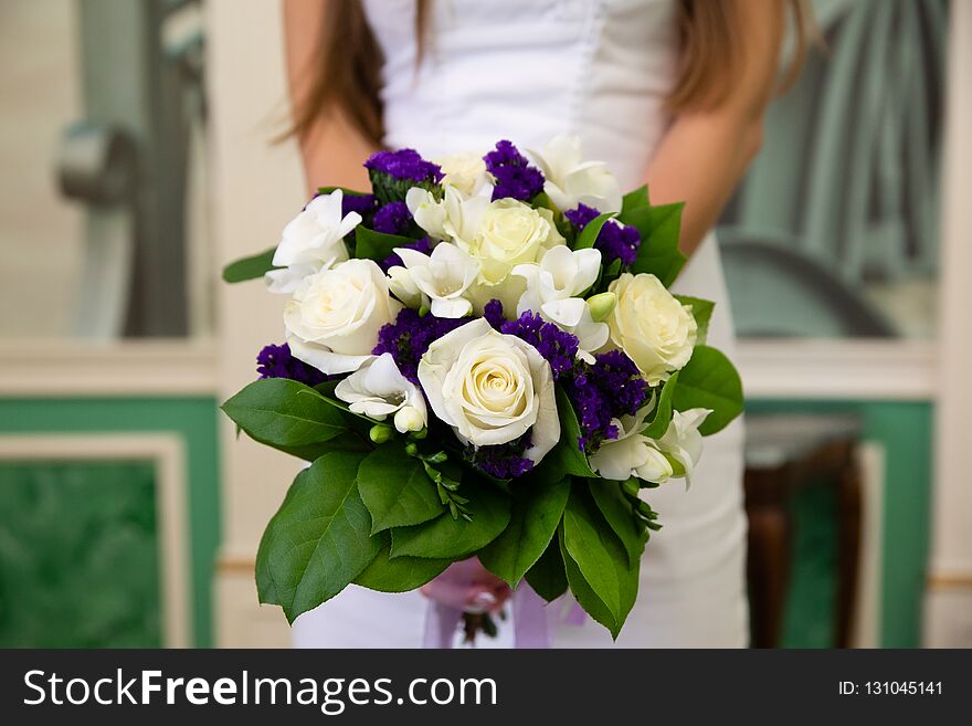 Wedding bouquet of flowers in the hands of the bride. Wedding bouquet of flowers in the hands of the bride