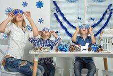 Merry Christmas And Happy Holidays!Mother And Two Sons Having Fun While Creating Christmas Decor. Stock Image